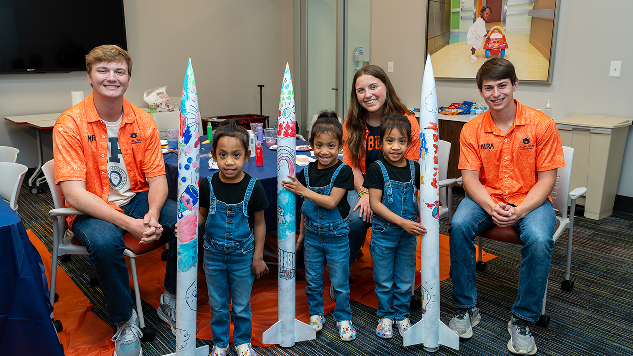 AURA members with patients painting rockets