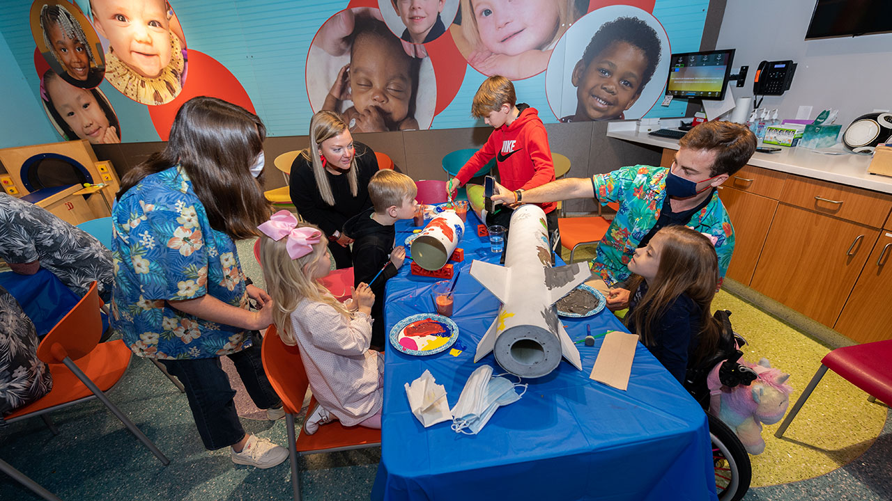 AURA students and patients decorating rocket